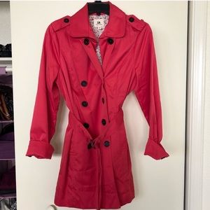 Pink raincoat with floral lining and black buttons